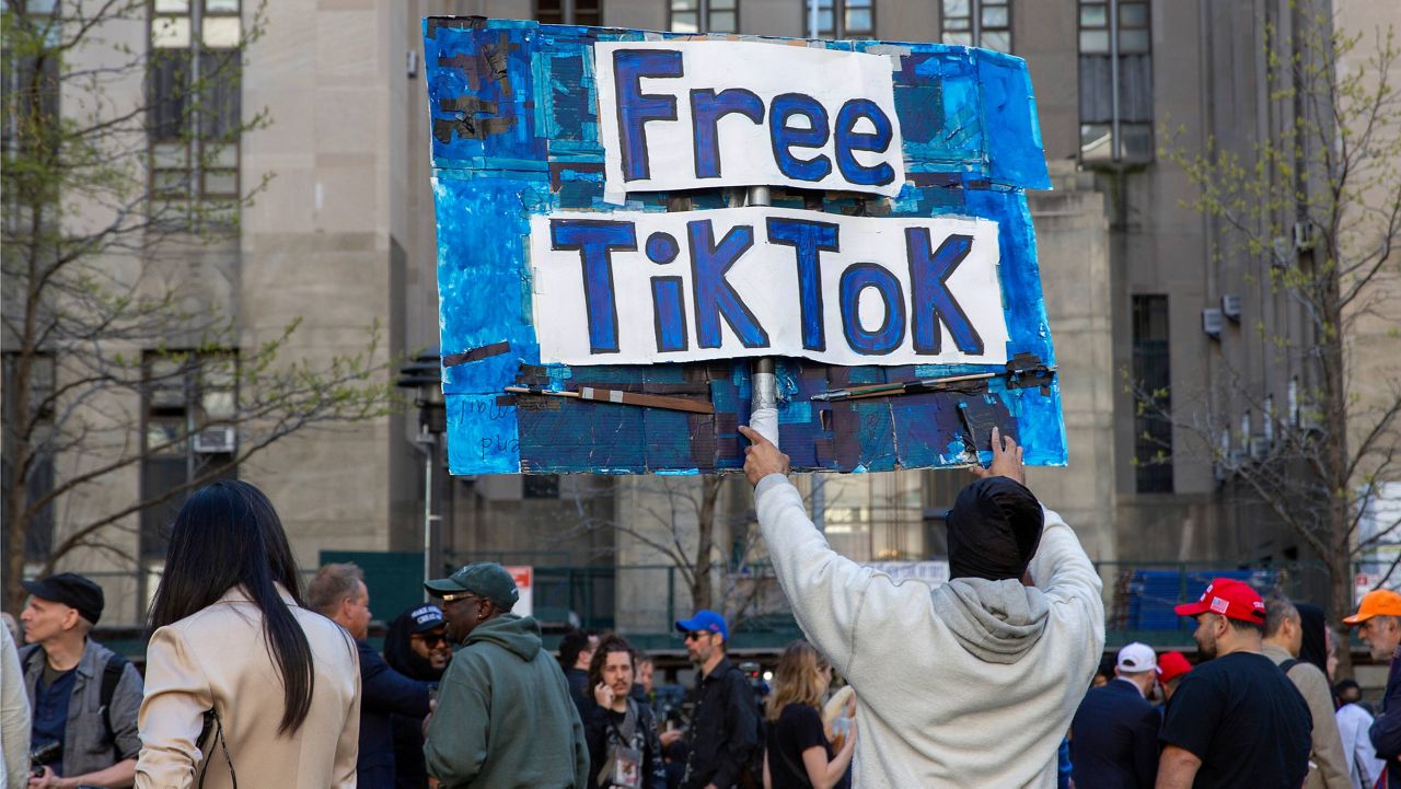 A man carries a Free TikTok sign in front of the courthouse where the hush-money trial of Donald Trump was underway on April 15, 2024, in New York. (AP Photo/Ted Shaffrey, File)