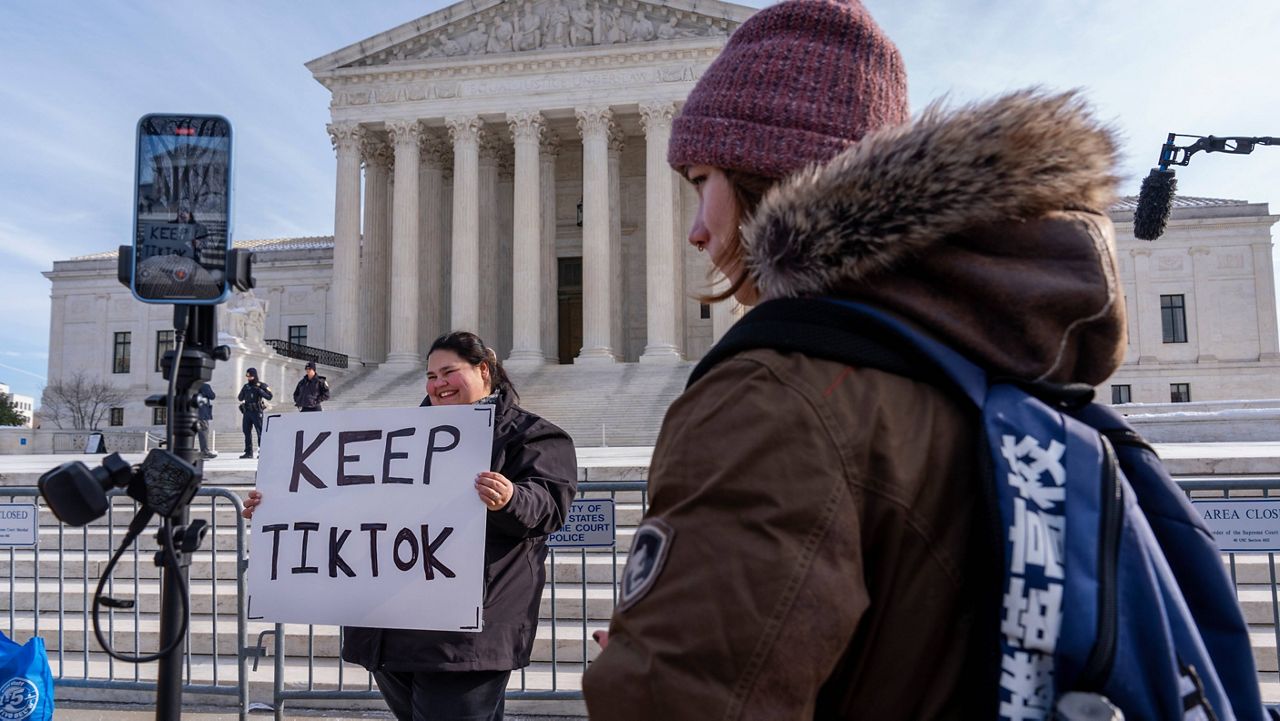 Callie Goodwin, of Columbia, S.C., holds a sign in support of TikTok outside the Supreme Court, Friday, Jan. 10, 2025, in Washington. Goodwin, a small business owner who sells personalized greeting cards, says 80% of her sales come from people who found her on TikTok. (AP Photo/Jacquelyn Martin)