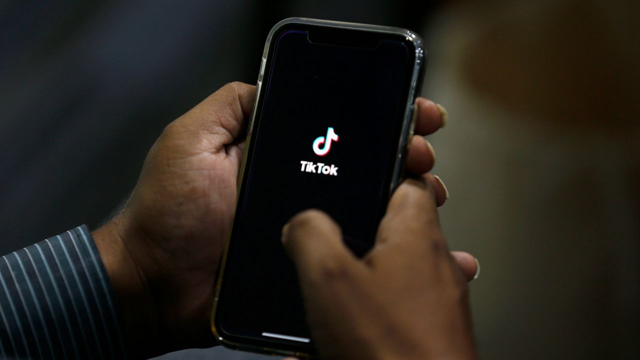FILE - In this July 21, 2020 file photo, a man opens social media app 'TikTok' on his cell phone. (AP Photo/Anjum Naveed, File)