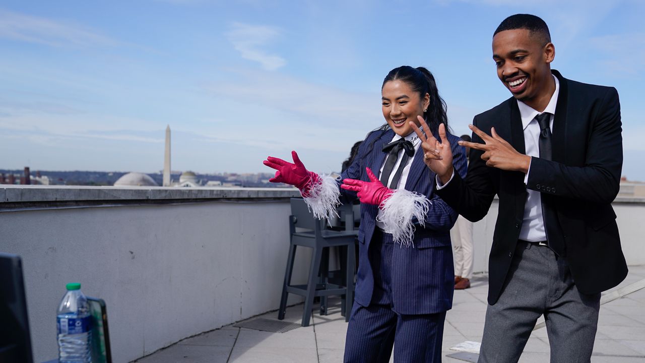TikTok influencers Janette Ok and Imani Carrier record a video during a media availability, Wednesday, March 22, 2023, in Washington. (AP Photo/Jess Rapfogel)
