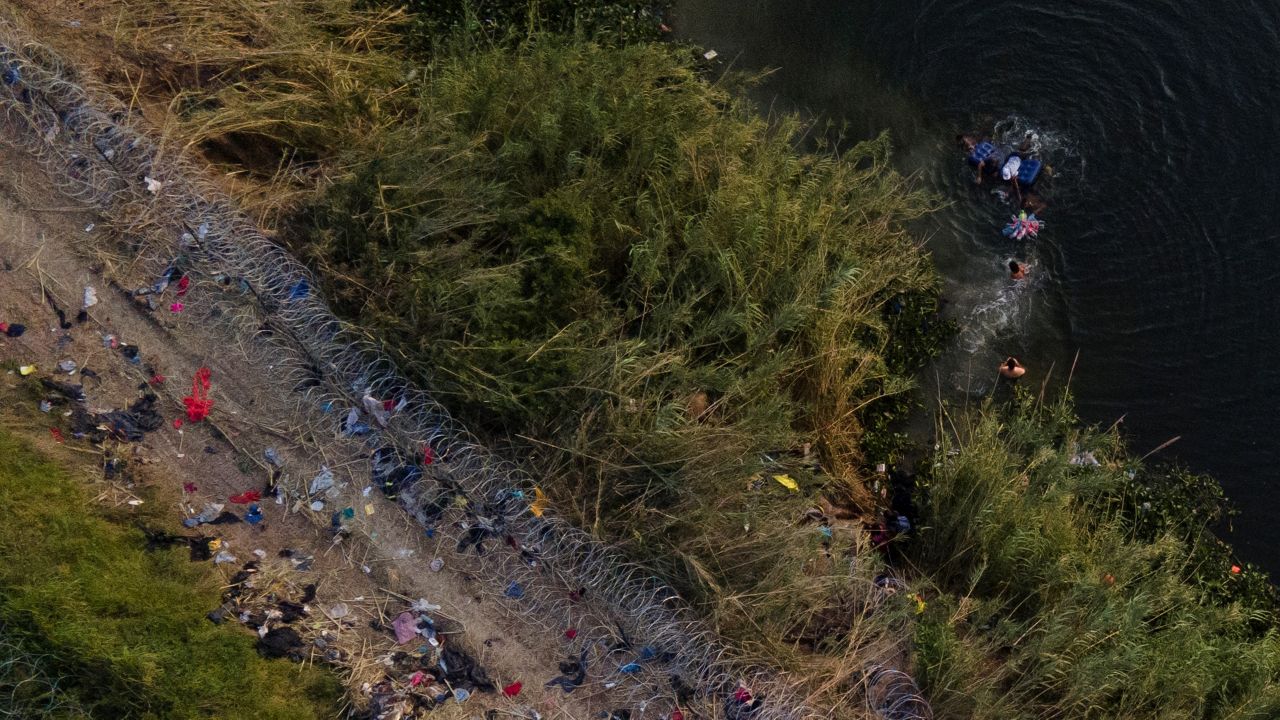 Migrants use a raft to cross the Rio Grande at the Texas-Mexico border, Thursday, May 11, 2023, in Brownsville, Texas. (AP Photo/Julio Cortez, File)