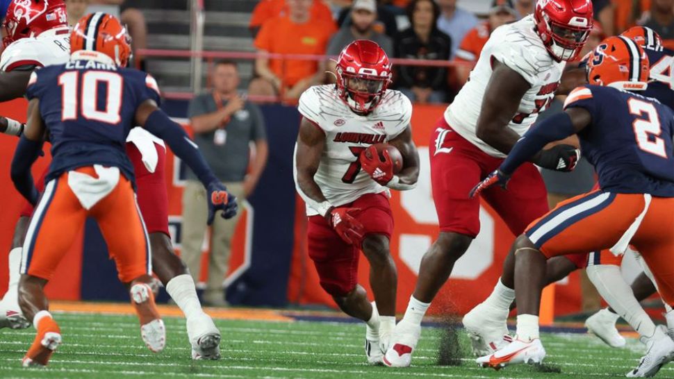 Louisville running back Tiyon Evans runs the ball up the middle in a game against the Syracuse Orange . (Louisville Athletics/Taris Smith)