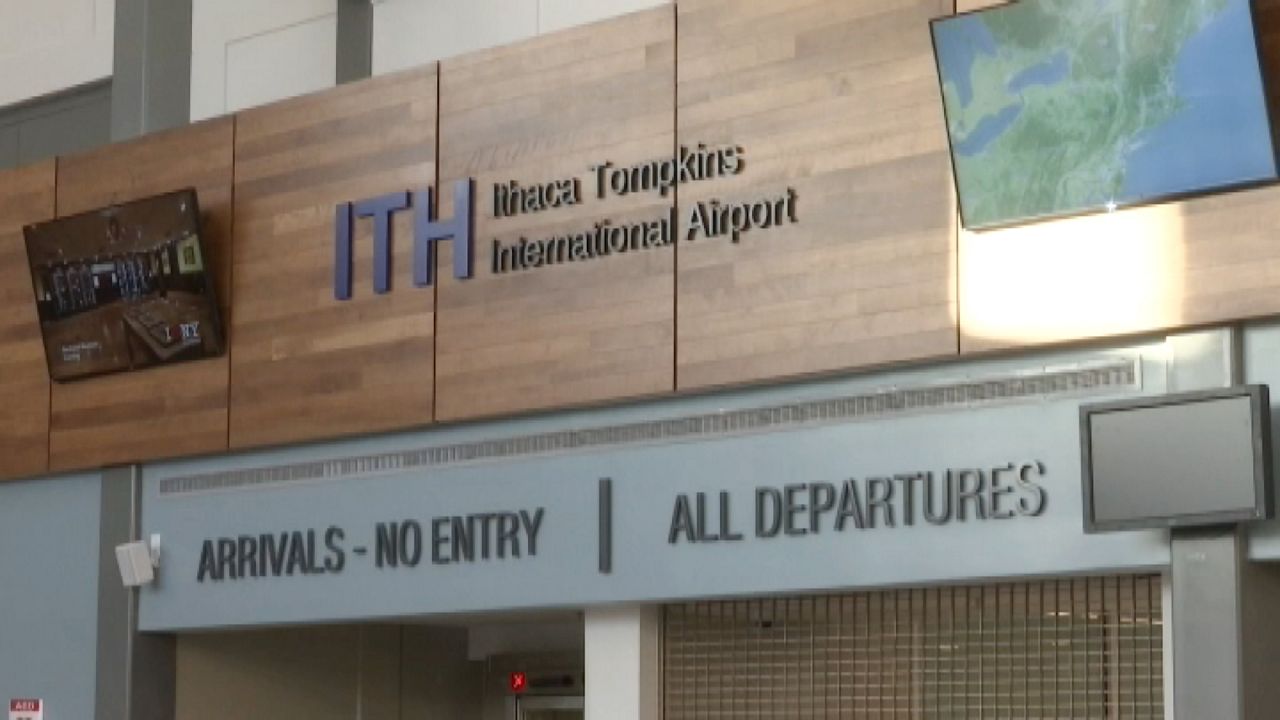 ithaca tompkins international airport sign over arrivals and departures gates