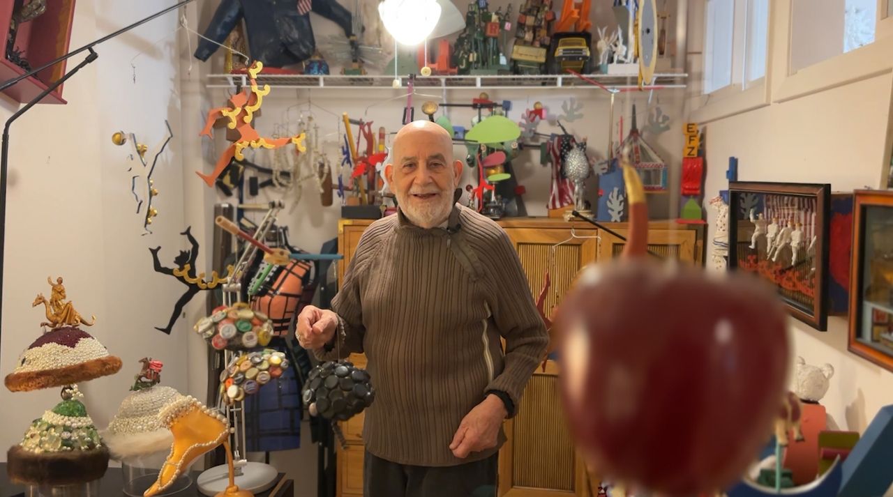 Tony Busalacchi smiles amongst his art collection