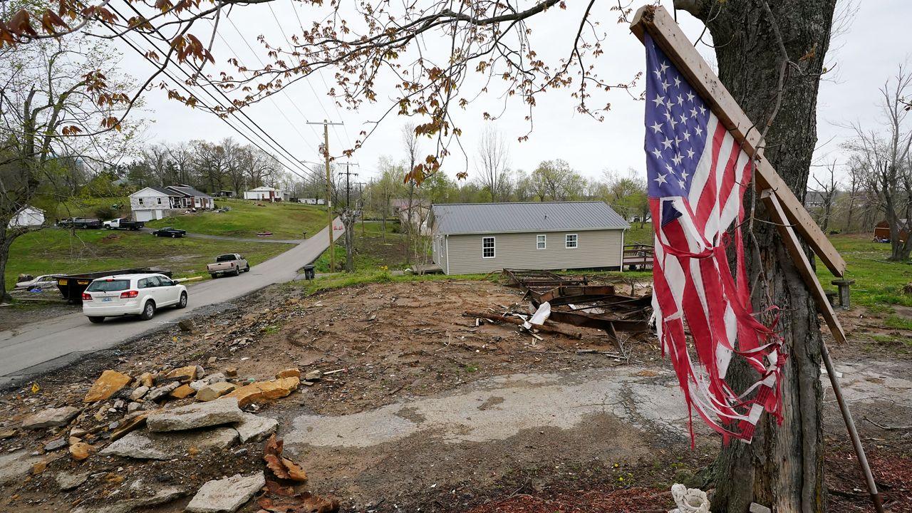A flag hangs near the remains of a home destroyed in a Dec. 10 tornado on April 21, 2022, in Dawson Springs, Tenn. Four months after a massive tornado tore through the state, hundreds of Kentuckians are arduously reconstructing their pre-storm existence. (AP Photo/Mark Humphrey)