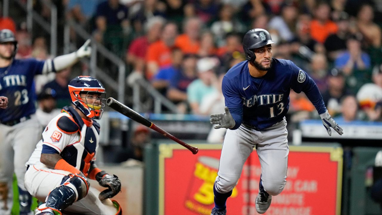 Seattle Mariners' Abraham Toro (13) watches his two-run single during the ninth inning of the team's baseball game against the Houston Astros, Saturday, July 30, 2022, in Houston. (AP Photo/Eric Christian Smith)
