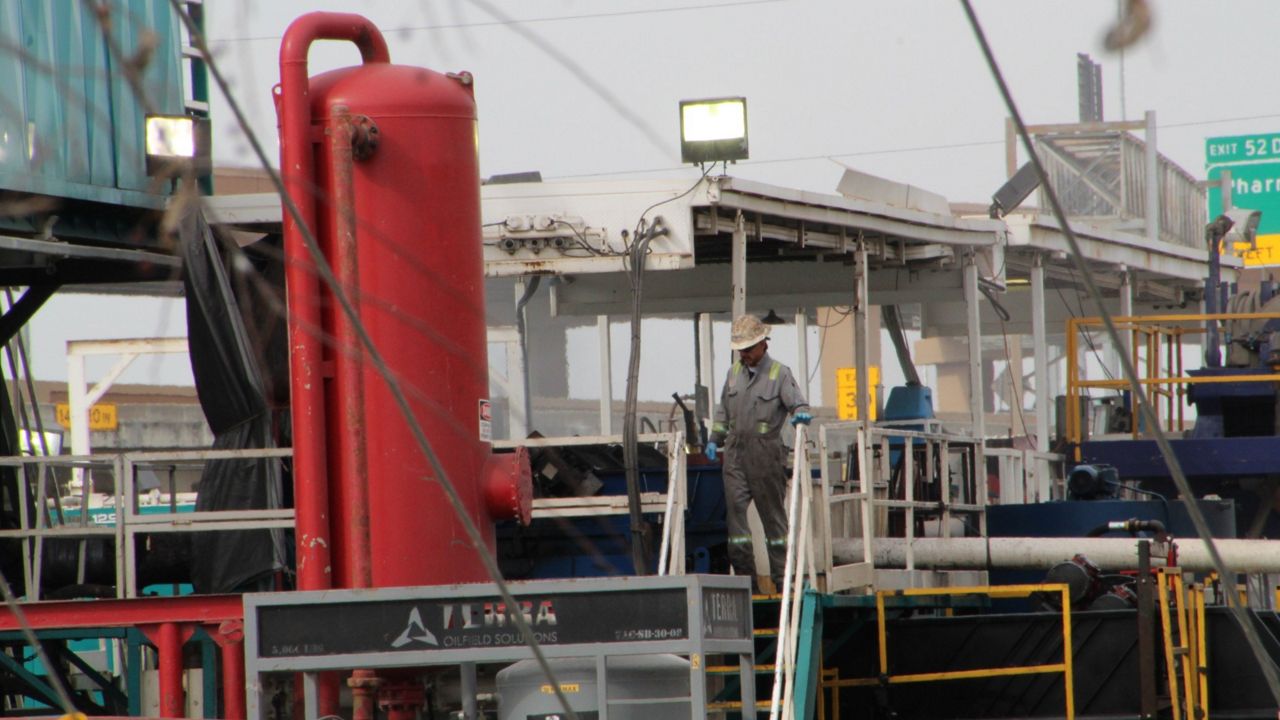 A worker on a gas drilling pad site. 