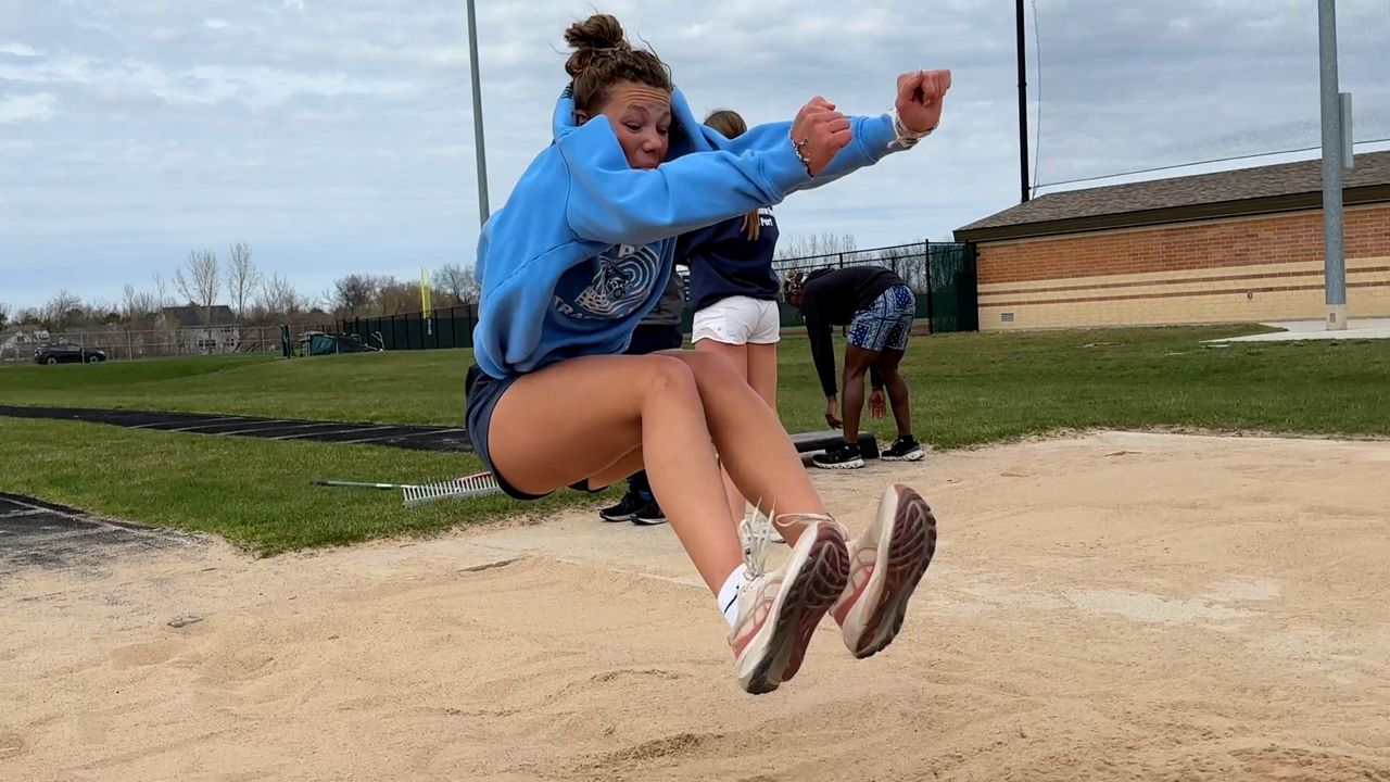 Madeline Thoreson jumps in the sand pit during practice
