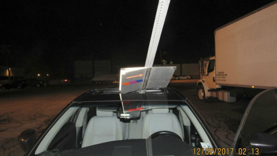 A photo provided by the South Hackensack Police Department shows a car with a mass transit sign sticking out of the roof. New Jersey police say a woman was drunk when she continued driving with a mass transit sign sticking out of the roof of her car. The 52-year-old was pulled over Saturday, Dec. 2, 2017, on Route 46 in South Hackensack and has been charged with driving with intoxicated and careless driving. (South Hackensack Police Department)