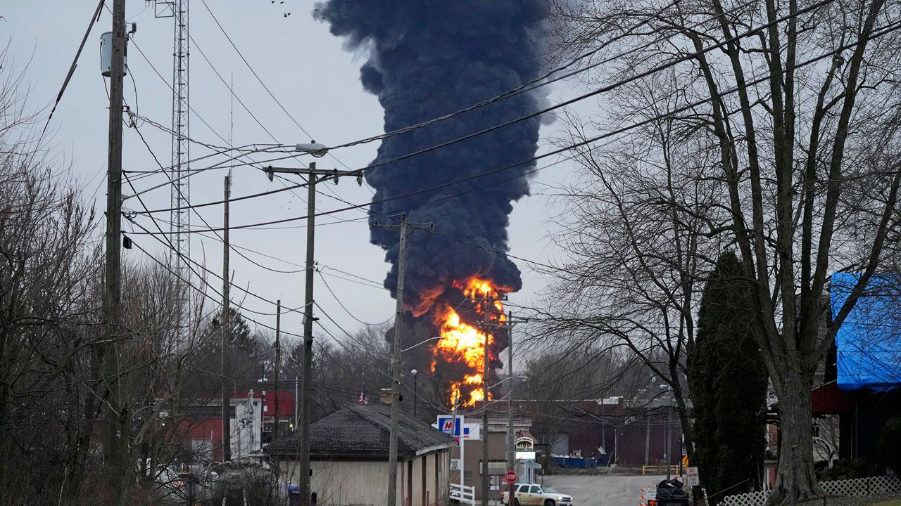 A black plume rises over East Palestine, Ohio, as a result of a controlled detonation of a portion of the derailed Norfolk Southern Monday, Feb. 6, 2023. (AP Photo/Gene J. Puskar)