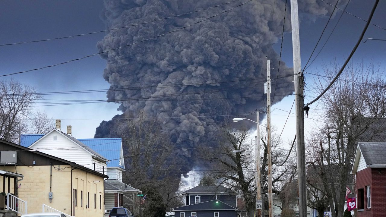 A black plume rises over East Palestine, Ohio, as a result of a controlled detonation of a portion of the derailed Norfolk Southern trains, Feb. 6, 2023. West Virginia's water utility says it's taking precautionary steps following the derailment of a train hauling chemicals that later sent up a toxic plume in Ohio. The utility said in a statement on Sunday, Feb. 16, 2023 that it has enhanced its treatment processes even though there hasn’t been a change in raw water at its Ohio River intake. (AP Photo/Gene J. Puska)