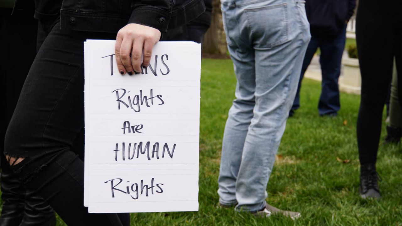 A sign reading "TRANS rights are HUMAN rights" is held during a pro-LGBTQ rally in Frankfort, Ky. (Spectrum News 1/Mason Brighton)