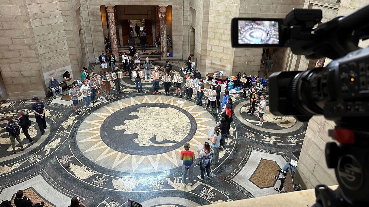 Protesters gather inside the State Capitol building on Friday, May 19, 2023, in Lincoln, Neb., before lawmakers were scheduled to begin debating a bill that will ban abortions at 12 weeks of pregnancy and also ban gender-affirming care for transgender minors. (AP Photo/Nick Ingram, File)