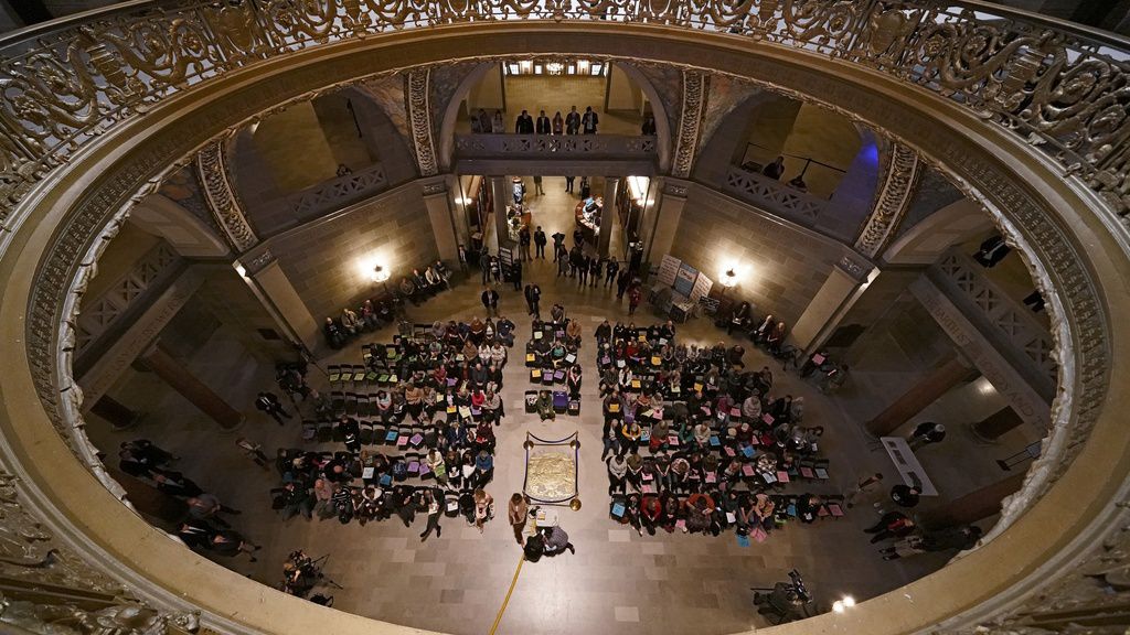 People listen to a speaker during a rally in favor of a ban on gender-transition health care legislation, Monday, March 20, 2023, at the Missouri Statehouse in Jefferson City, Mo. (AP Photo/Charlie Riedel)