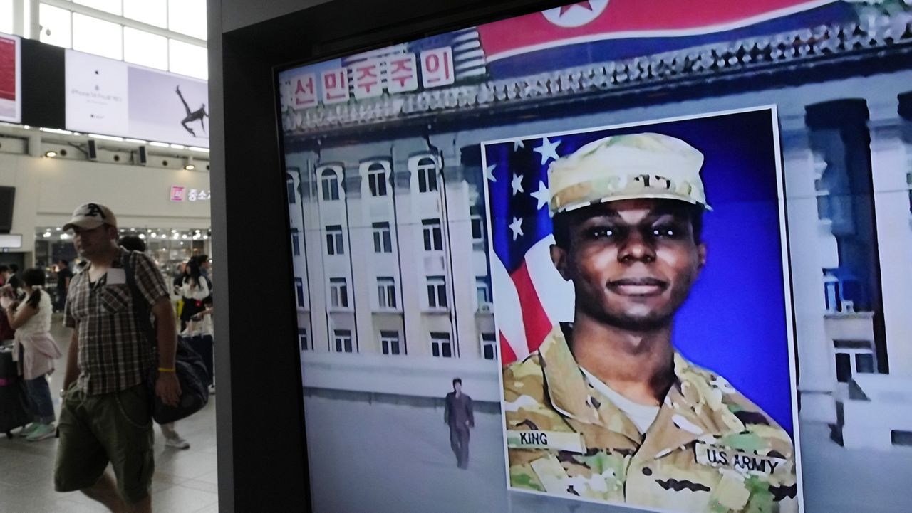 A television screen shows a file image of Pvt. Travis King during a news program at the Seoul Railway Station in Seoul, South Korea Aug. 16, 2023. King, who fled to North Korea just over a year ago, will plead guilty to desertion and four other charges and take responsibility for his conduct. (AP Photo/Ahn Young-joon, File)