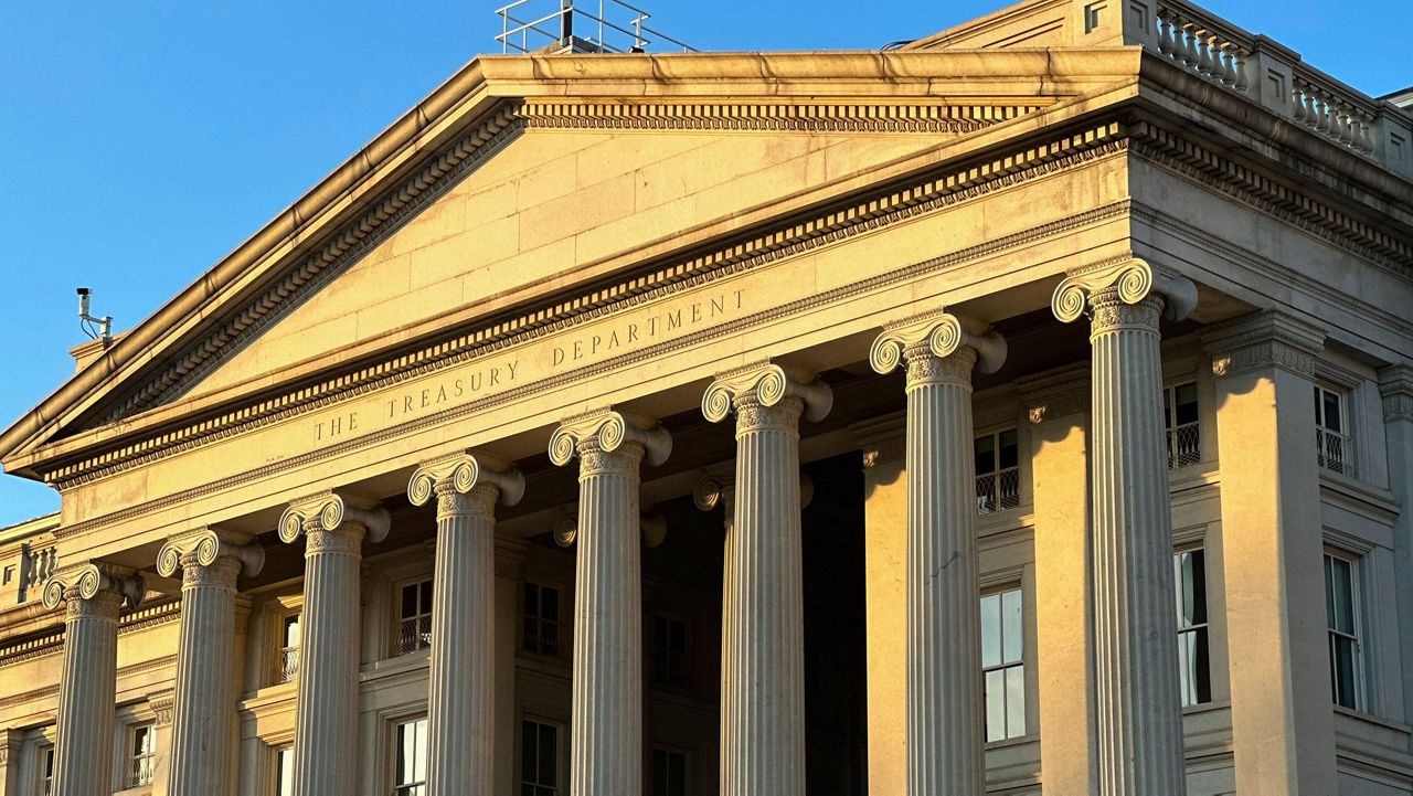 The Treasury Department is seen near sunset in Washington, Wednesday, Jan. 18, 2023. (AP Photo/Jon Elswick)