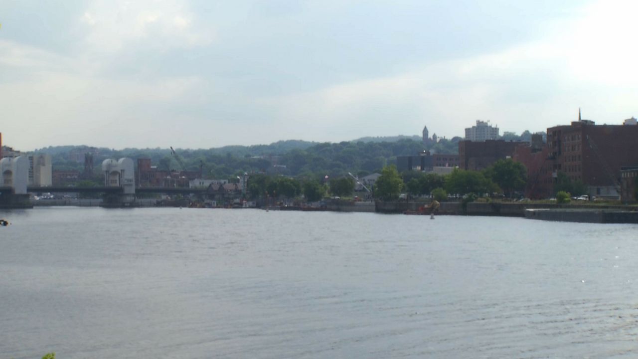 downtown troy and collar city bridge with hudson river in foreground