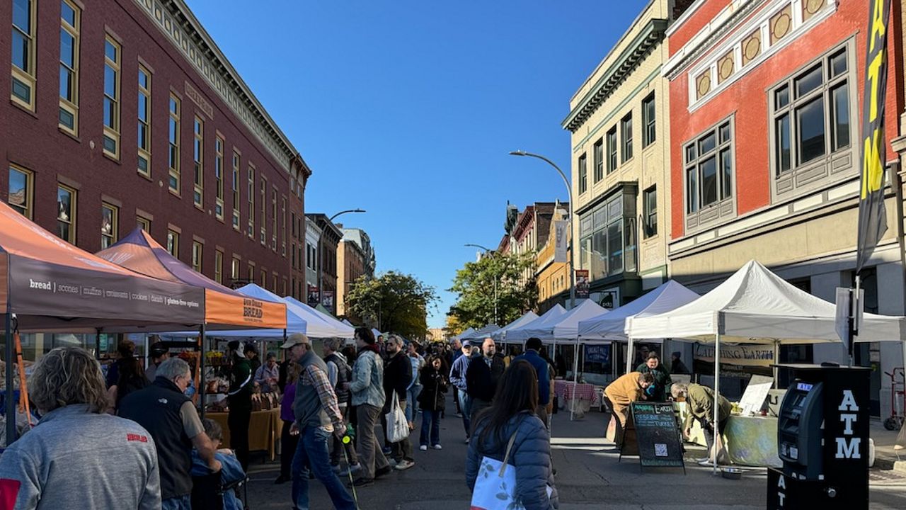 people milling about at troy farmers market on sunny morning