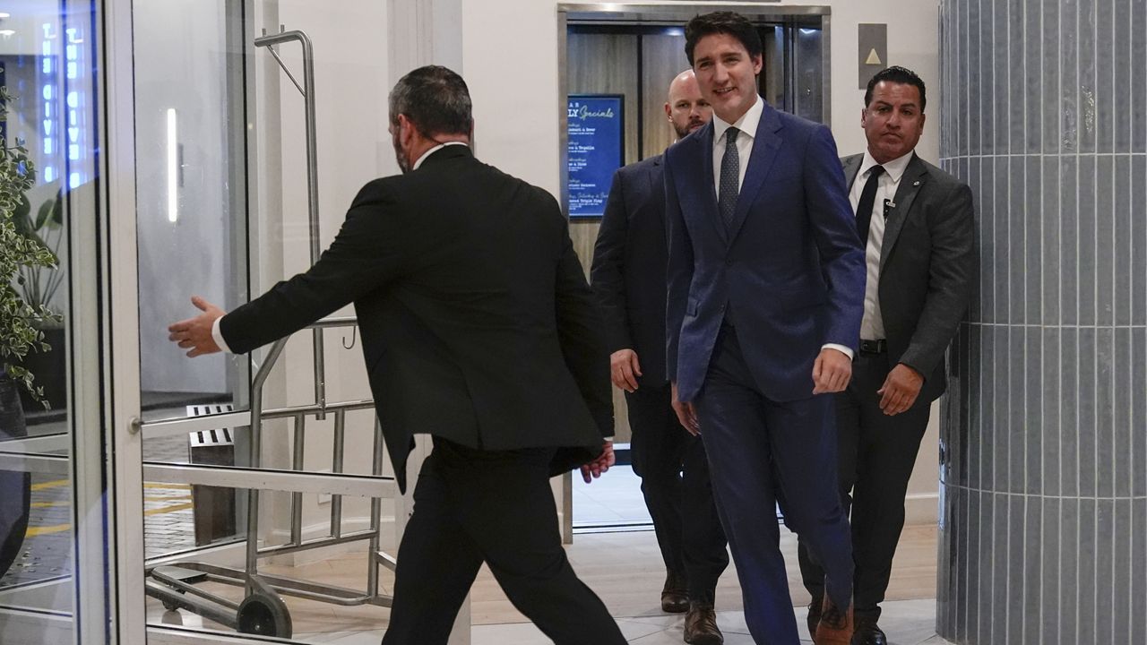 Canadian Prime Minister Justin Trudeau walks through the lobby of the Delta Hotel by Marriott, Friday, Nov. 29, 2024, in West Palm Beach, Fla. (AP Photo/Carolyn Kaster)