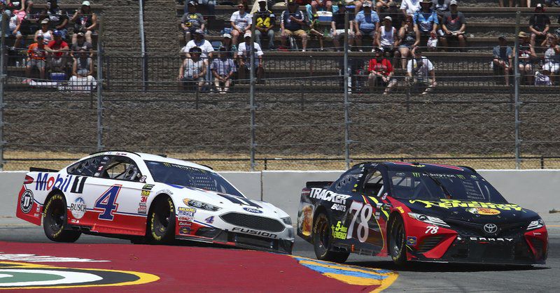Martin Truex Jr. (78) leads Kevin Harvick (4) through a turn during a NASCAR Sprint Cup Series auto race Sunday, June 24, 2018, in Sonoma, Calif. (AP Photo/Ben Margot)