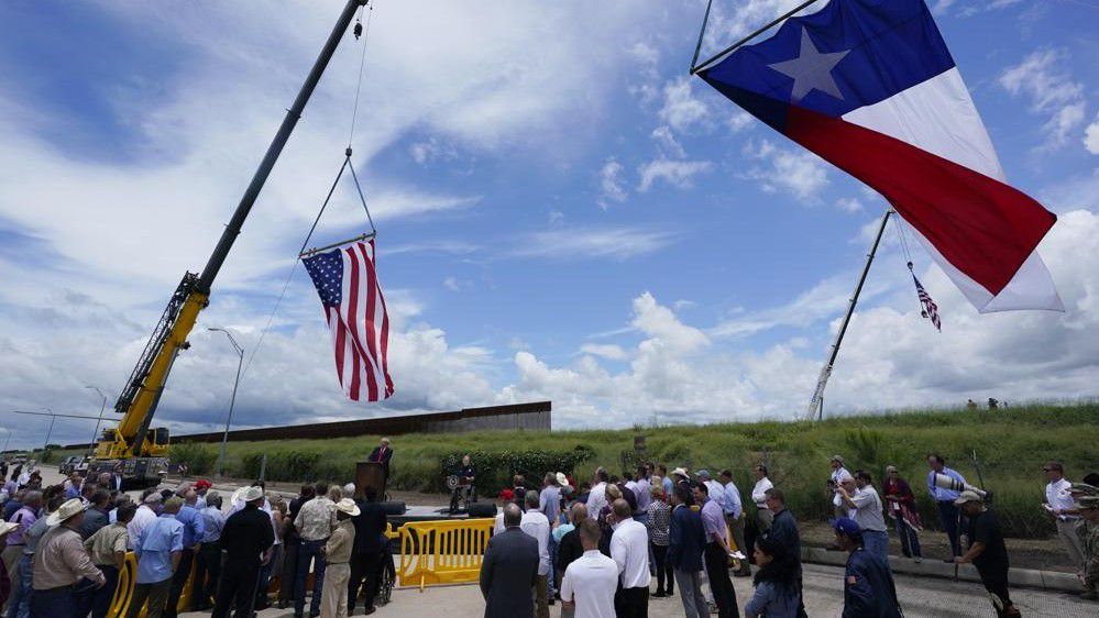 Former President Donald Trump, left, and Texas Gov. Greg Abbott, right, speak during a stop at an unfinished section of border wall, in Pharr, Texas, Wednesday, June 30, 2021. (AP Photo/Eric Gay)