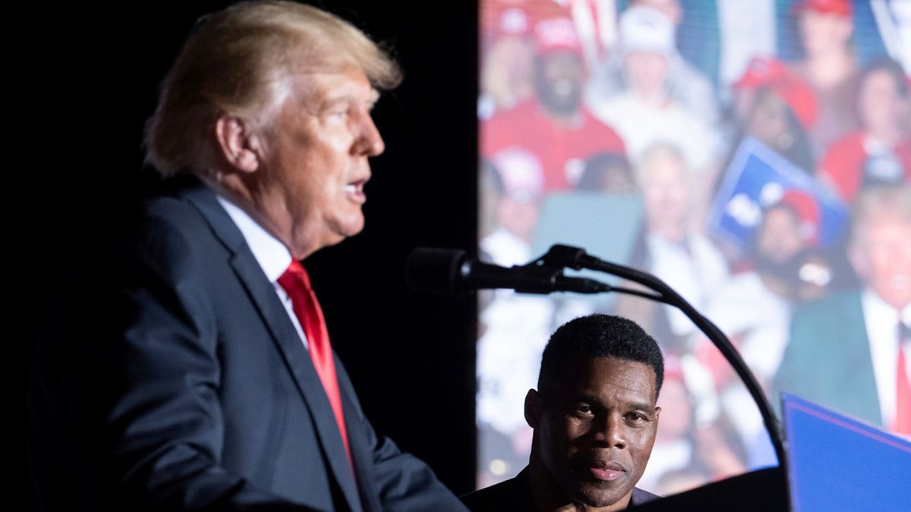 Former President Donald Trump speaks as Georgia Senate candidate Herschel Walker listens during his Save America rally in Perry, Ga., on Saturday, Sept. 25, 2021. (AP Photo/Ben Gray)