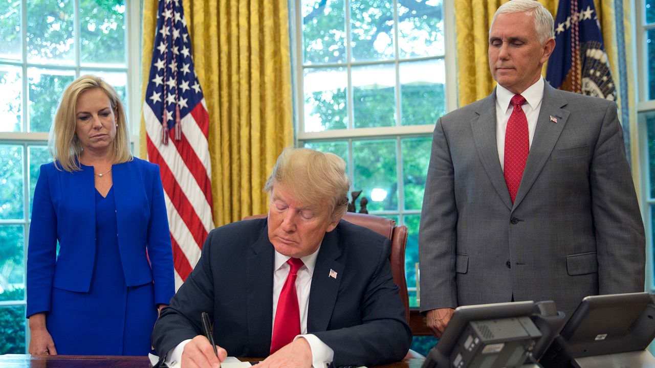 President Donald Trump signs an order that will keep families together at the border in this image from June 20, 2018. (AP Photo)