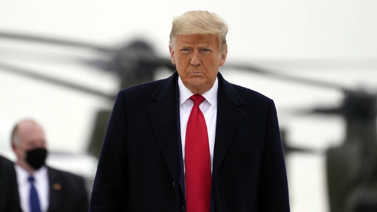 President Donald Trump boards Air Force One upon arrival at Valley International Airport, Tuesday, Jan. 12, 2021, in Harlingen, Texas, after visiting a section of the border wall with Mexico in Alamo, Texas. (AP Photo/Alex Brandon)