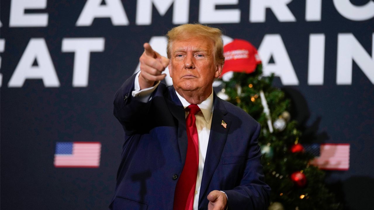 Former President Donald Trump points to supporters during rally Dec. 19, 2023, in Waterloo, Iowa. (AP Photo/Charlie Neibergall, File)