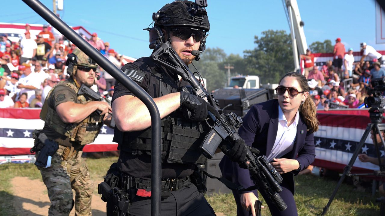 U.S. Secret Service agents respond as Republican presidential candidate and former President Donald Trump is surrounded on stage by U.S. Secret Service agents at a campaign rally, July 13, 2024, in Butler, Pa. (AP Photo/Evan Vucci, File)