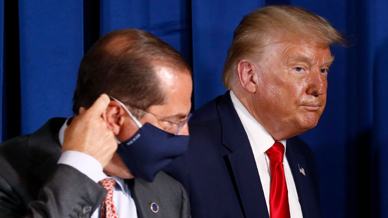 President Donald Trump and Health and Human Services Secretary Alex Azar attend a roundtable discussion on the coronavirus outbreak on July 31, 2020, in Belleair, Fla. (AP Photo/Patrick Semansky)