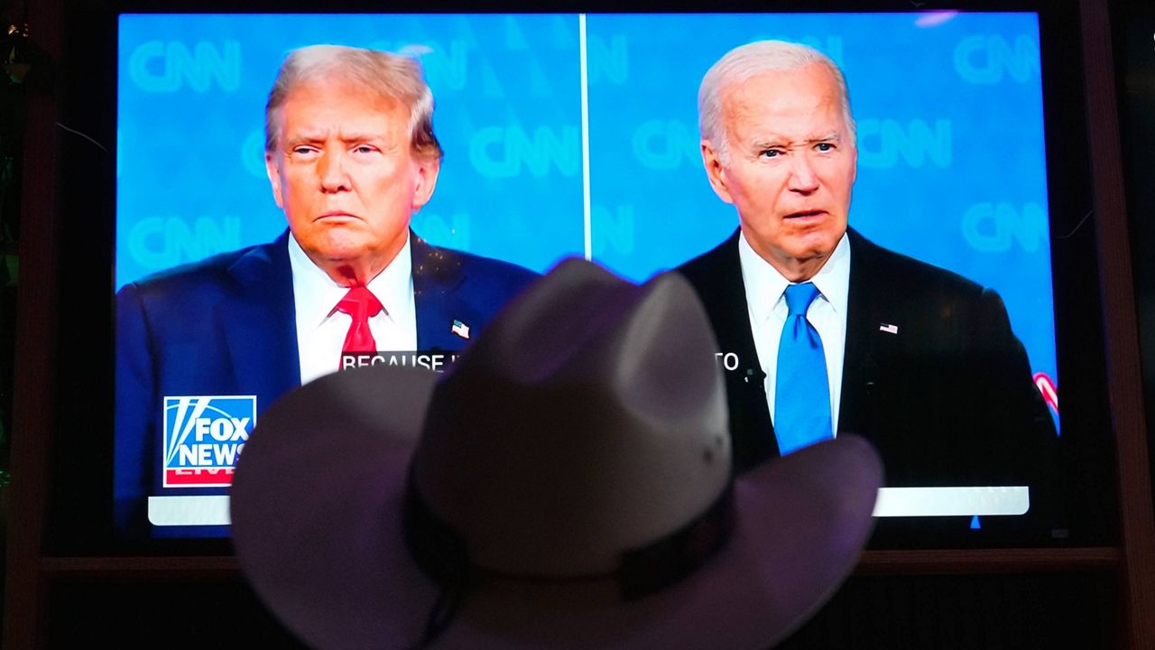 Roger Strassburg, of Scottsdale, Ariz., wears a cowboy hat as he watches the presidential debate between President Joe Biden and Republican presidential candidate and former President Donald Trump at a debate watch party Thursday, June 27, 2024, in Scottsdale, Ariz. (AP Photo/Ross D. Franklin)