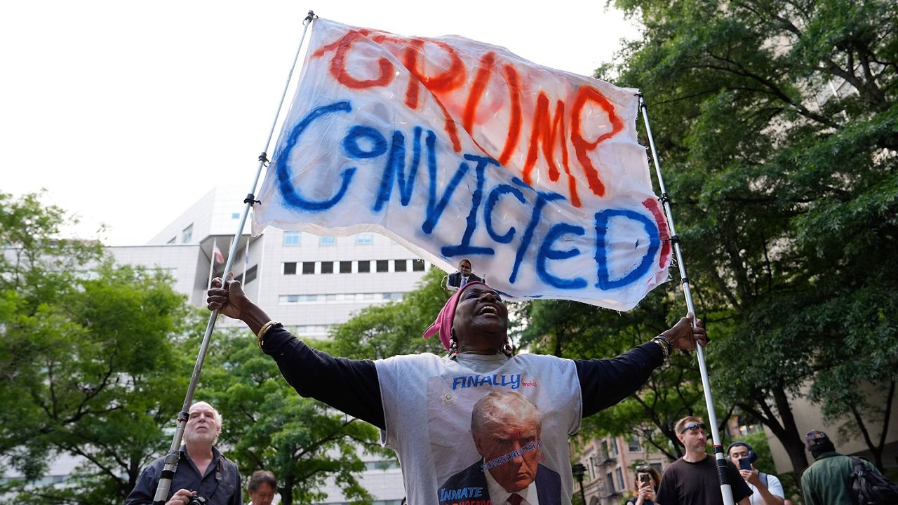 A demonstrator reacts to the guilty verdict announced against former President Donald Trump outside Manhattan Criminal Court, Thursday, May 30, 2024, in New York. 