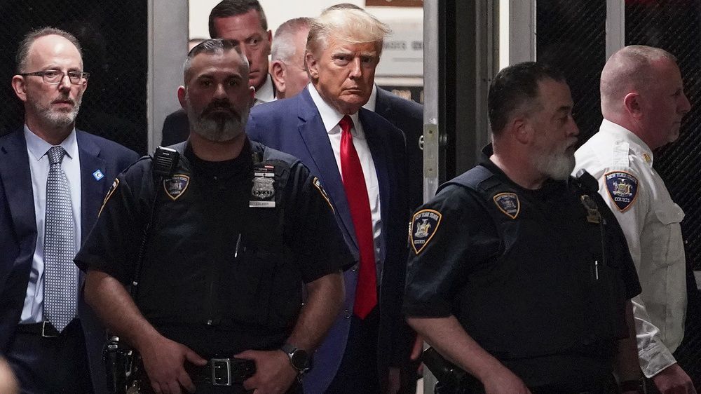 Former President Donald Trump is escorted to a courtroom, Tuesday, April 4, 2023, in New York. (AP Photo/Mary Altaffer)