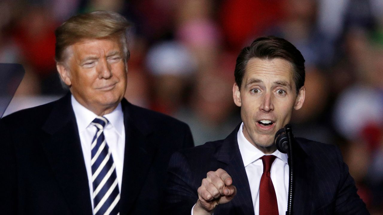 President Donald Trump listens as then-Republican Senate candidate Josh Hawley speaks during a campaign rally at Columbia Regional Airport, Thursday, Nov. 1, 2018, in Columbia, Mo. (AP Photo/Charlie Riedel, File)