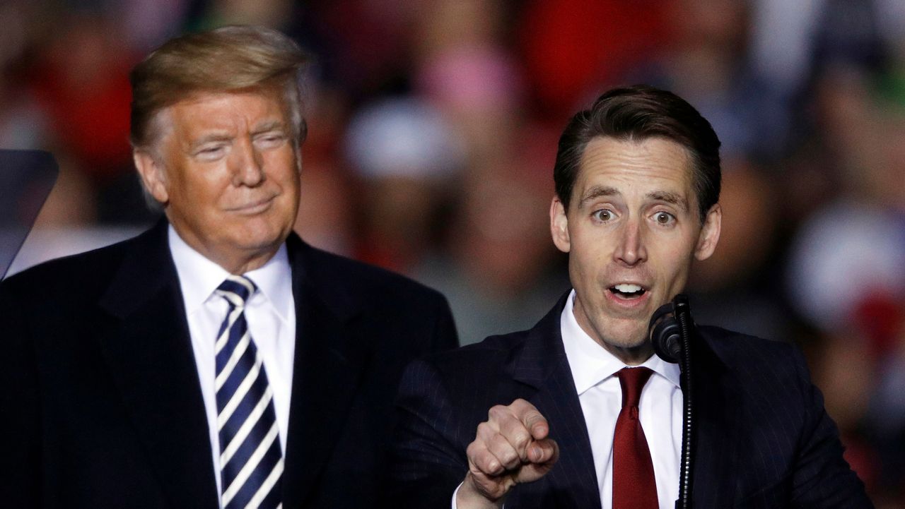 President Donald Trump listens as Republican Senate candidate Josh Hawley speaks during a campaign rally at Columbia Regional Airport, Thursday, Nov. 1, 2018, in Columbia, Mo. (AP Photo/Charlie Riedel, File)