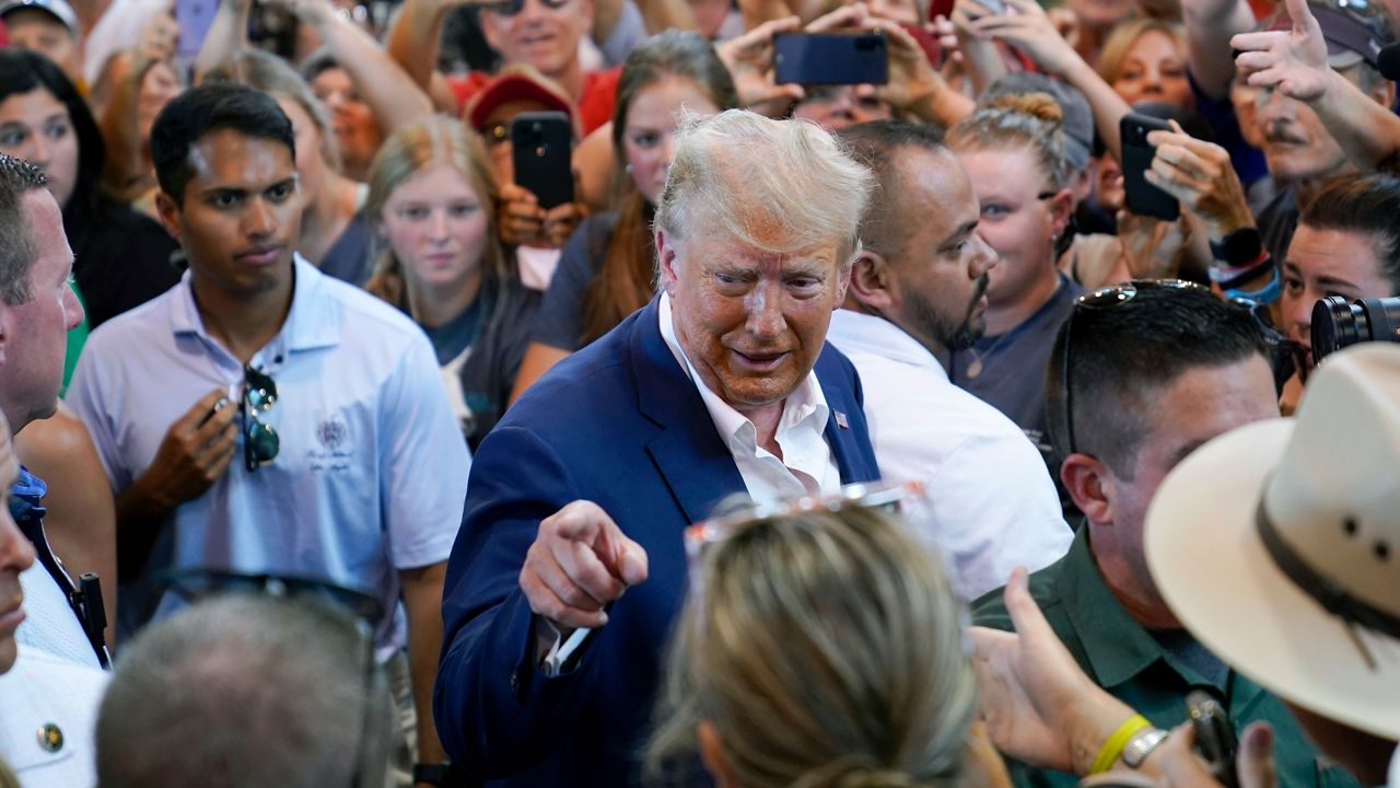 Donald Trump reacts as he greets supporters during a visit to the Iowa State Fair on Saturday, Aug. 12, 2023 in Des Moines. (AP Photo/Charlie Neibergall)