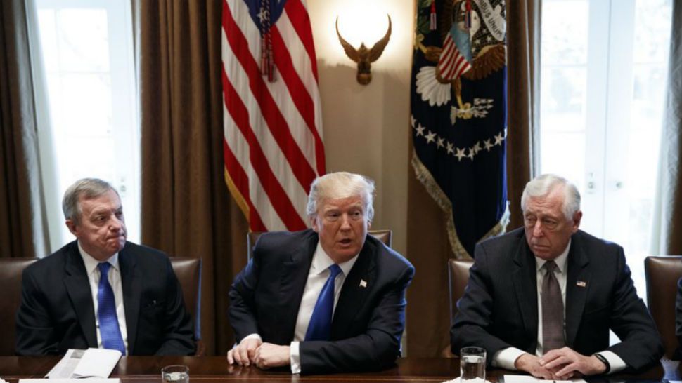 In this Jan. 9, 2017 photo, Sen. Dick Durbin, D-Ill, left, and Rep. Steny Hoyer, D-Md, listen as President Donald Trump speaks during a meeting with lawmakers on immigration policy in the Cabinet Room of the White House in Washington. (AP Photo/Evan Vucci) 