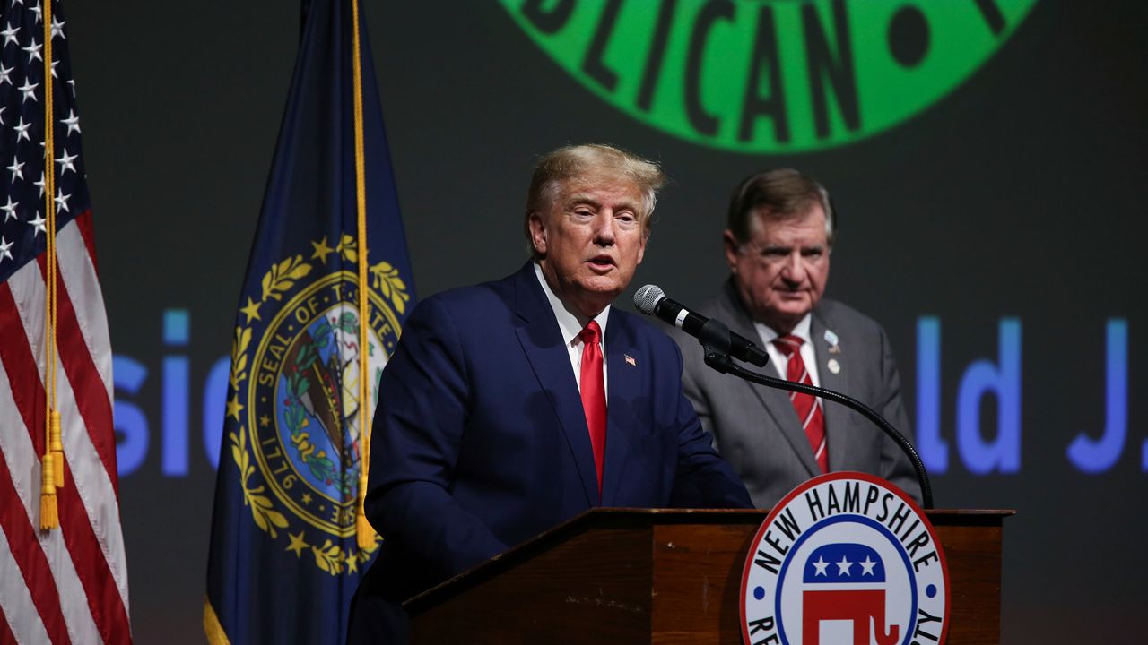 Former President Donald Trump speaks as outgoing Chairman of the New Hampshire GOP Stephen Stepanek looks on during the New Hampshire Republican State Committee 2023 annual meeting, Saturday, Jan. 28, 2023, in Salem, N.H. (AP Photo/Reba Saldanha)