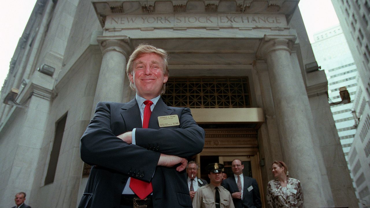 Donald Trump poses for photos outside the New York Stock Exchange after the listing of his stock on Wednesday, June 7, 1995 in New York.