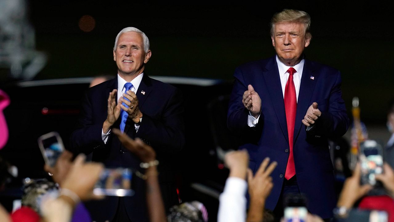 President Donald Trump and Vice President Mike Pence appear together at a campaign rally on Sept. 25, 2020, in Newport News, Va. (AP Photo/Steve Helber)