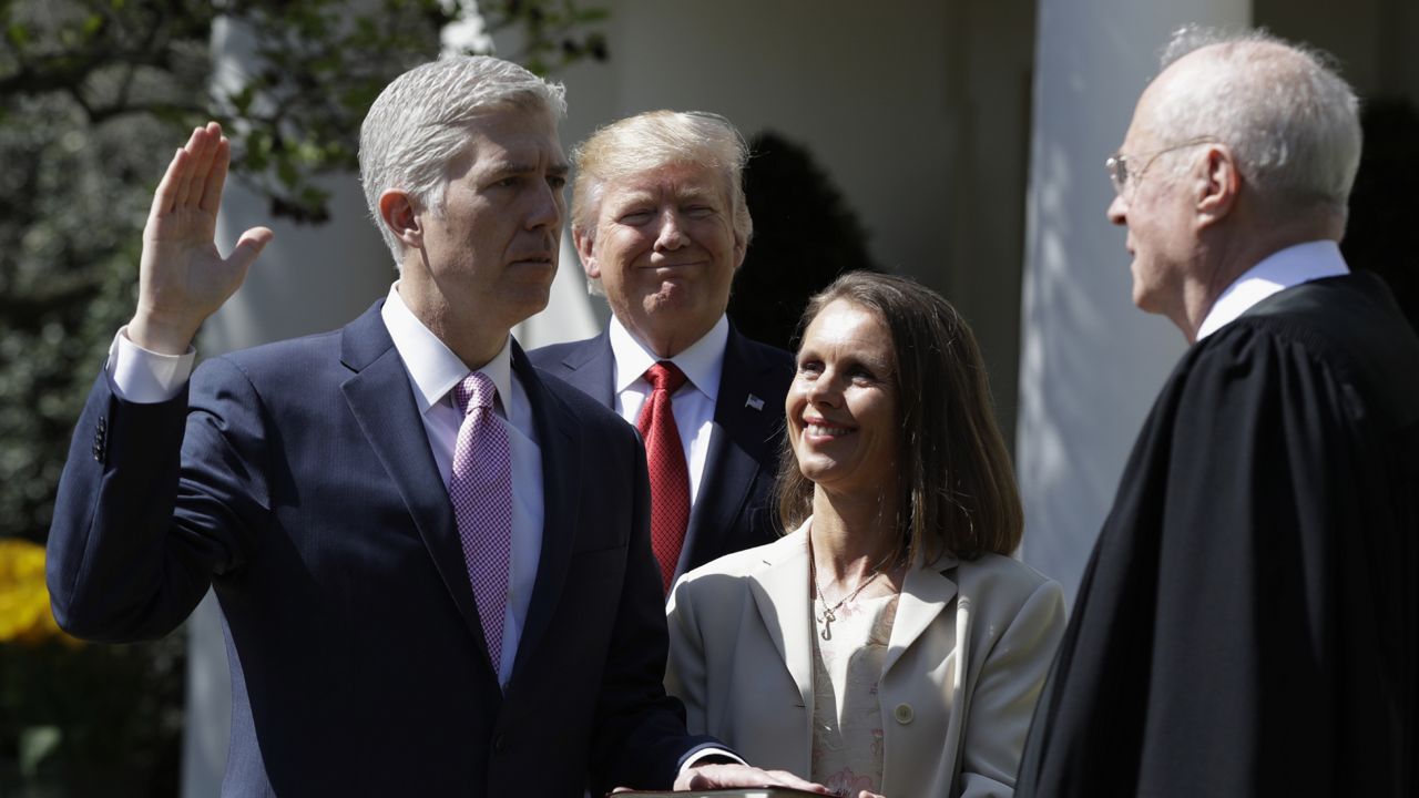 President Donald Trump watches as Supreme Court Justice Anthony Kennedy administers the judicial oath to Judge Neil Gorsuch (via Associated Press)