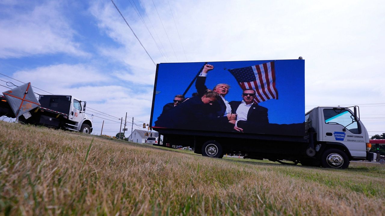 An electronic billboard displays images of former President Donald Trump from his recent rally at the Butler Farm Show, Thursday, July 18, 2024, in Butler, Pa. (AP Photo/Eric Gay)