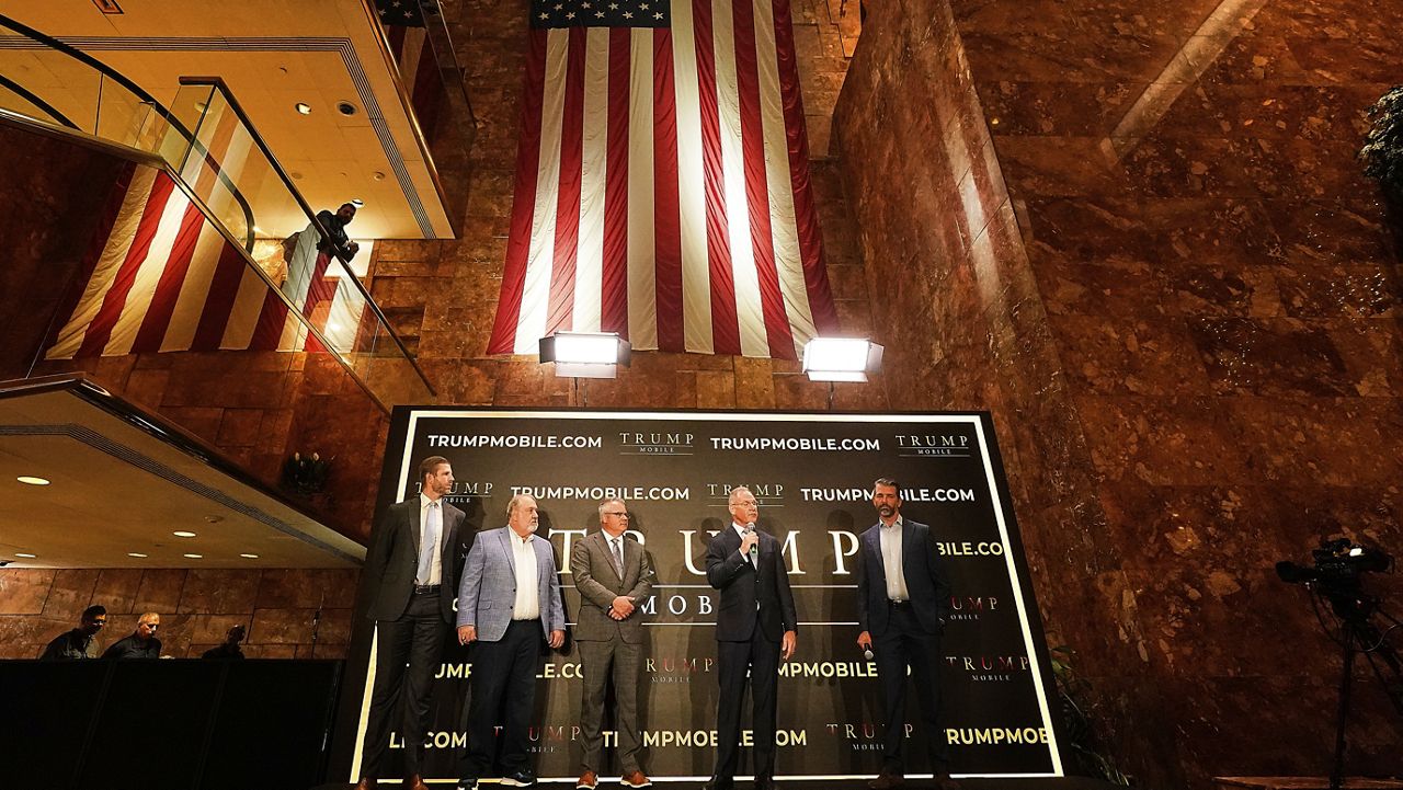 Eric Trump, Don Hendrickson, Eric Thomas, Patrick O'Brien and Donald Trump Jr., left to right, participate in the announcement of Trump Mobile, in New York's Trump Tower, Monday, June 16, 2025. (AP Photo/Richard Drew)