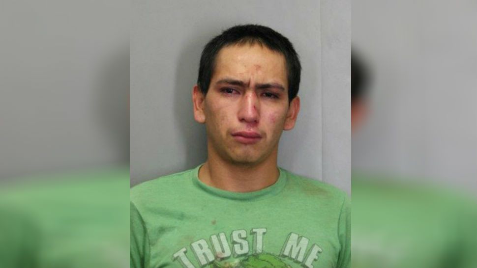 This December 2017 photo released by the Official Fairfax County Police Department shows Wilmer Lara Garcia, wearing a T-shirt emblazoned with "Trust Me," who was charged with auto theft and two counts of forgery after allegedly stealing a car with an accomplice in Fairfax County, Va. (Official Fairfax County Police Department via AP)