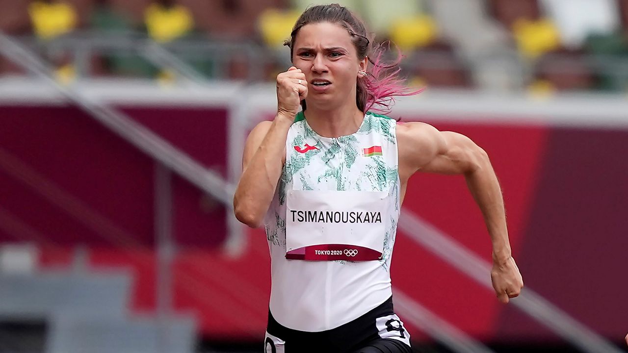 Krystsina Tsimanouskaya of Belarus runs in the women's 100-meter race at the 2020 Summer Olympics in Tokyo. (AP/Martin Meissner)