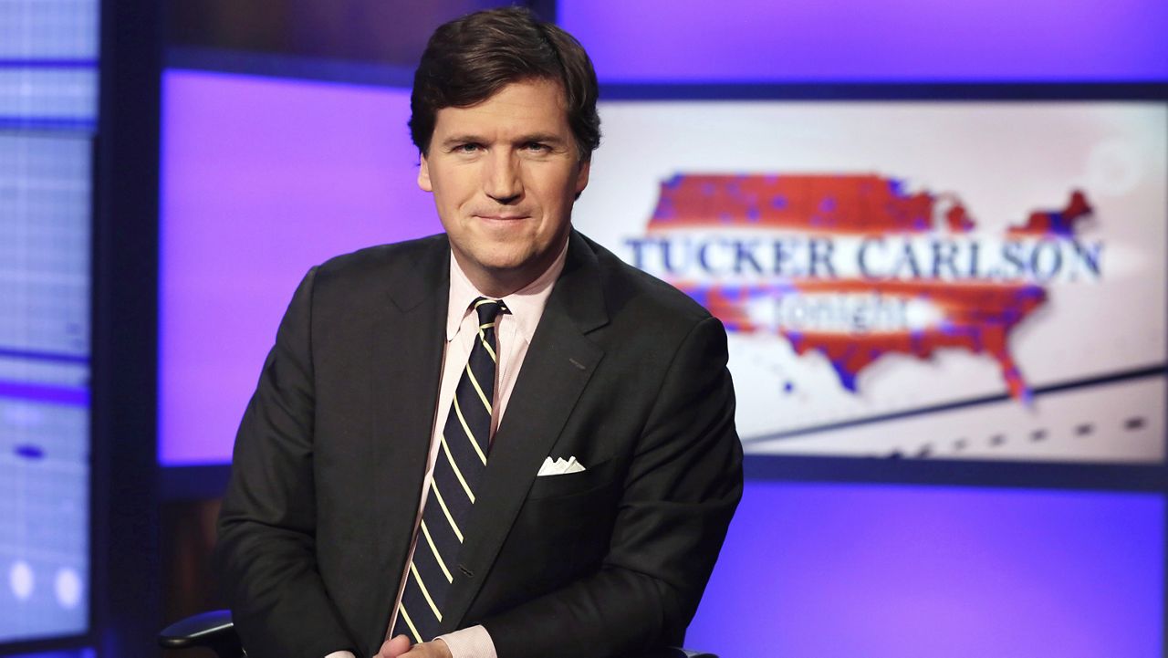 Tucker Carlson, host of "Tucker Carlson Tonight," poses for photos in a Fox News Channel studio on March 2, 2017, in New York. (AP Photo/Richard Drew, File)