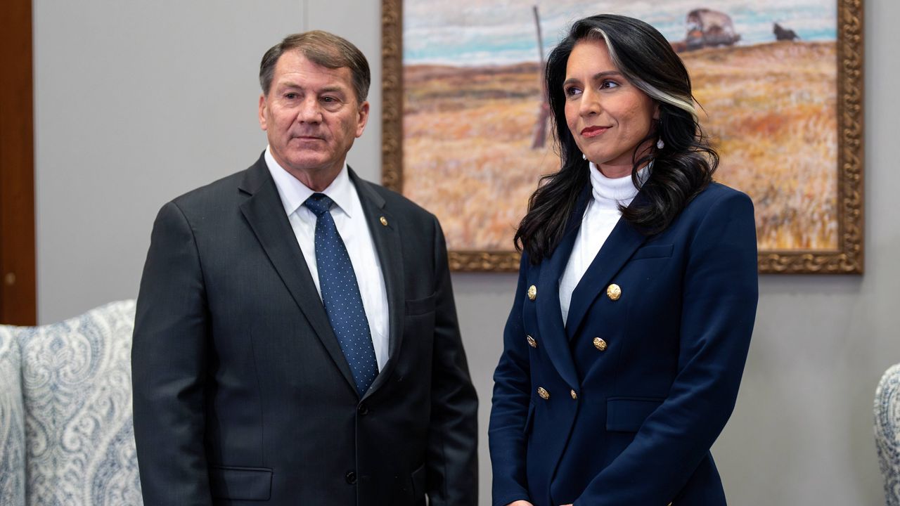 Tulsi Gabbard, President-elect Donald Trump's nominee to be director of National Intelligence, right, meets with Sen. Mike Rounds, R-S.D., a member of the Senate Intelligence Committee, at the Capitol in Washington, Monday, Dec. 9, 2024. (AP Photo/J. Scott Applewhite)