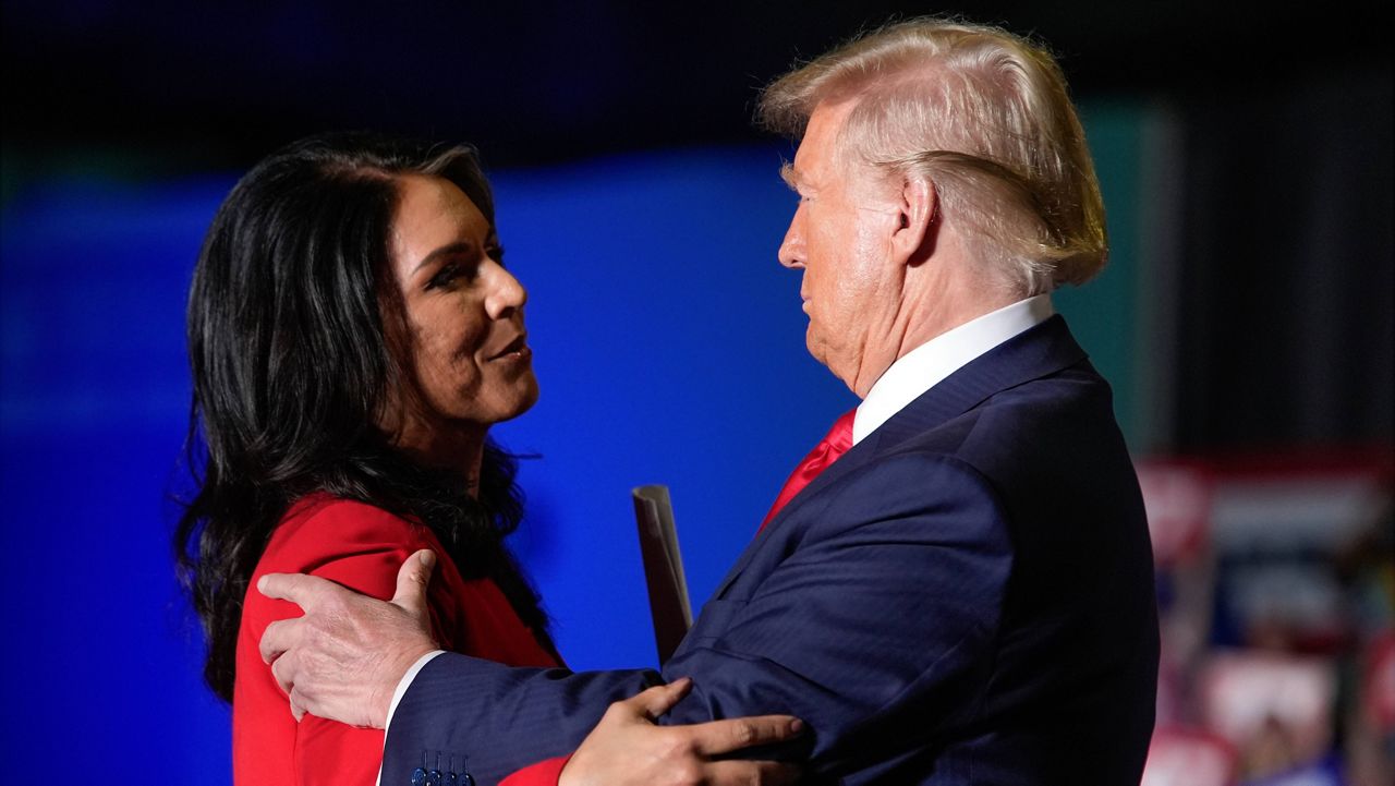 Republican presidential nominee former President Donald Trump hugs former Democratic Rep. Tulsi Gabbard during a campaign rally at Greensboro Coliseum, Tuesday, Oct. 22, 2024, in Greensboro, N.C. (AP Photo/Alex Brandon)