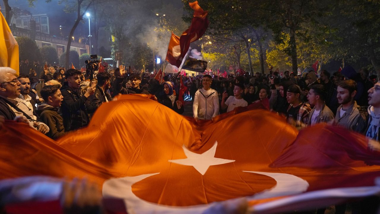 Supporters of President Recep Tayyip Erdogan celebrate Sunday outside AKP (Justice and Development Party) headquarters in Istanbul, Turkey. (AP Photo/Khalil Hamra)